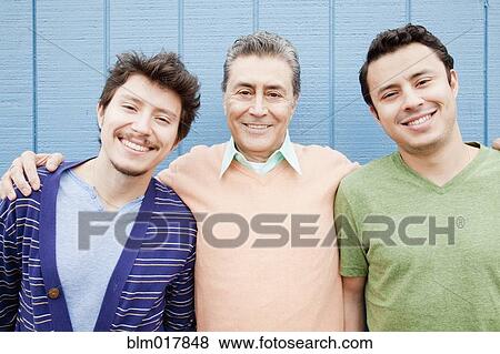 Stock Photo - Hispanic father and sons smiling. Fotosearch
