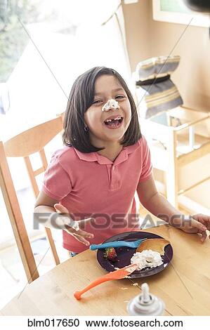 Hispanic girl playing with food at table View Large Photo Image Stock Image - Hispanic girl playing with food at table. Fotosearch