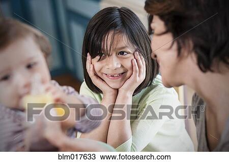 Hispanic mother with children in kitchen View Large Photo Image Stock Image - Hispanic mother with children in kitchen. Fotosearch
