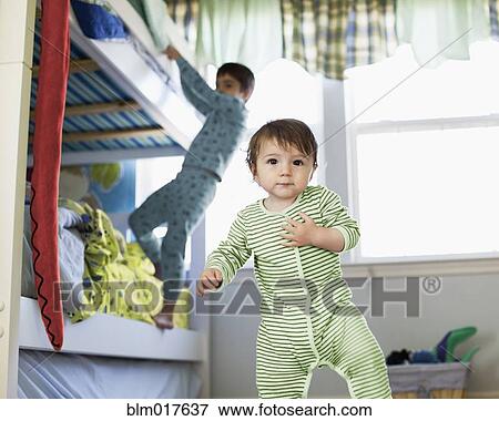 Stock Photo - Hispanic toddler standing in bedroom. Fotosearch