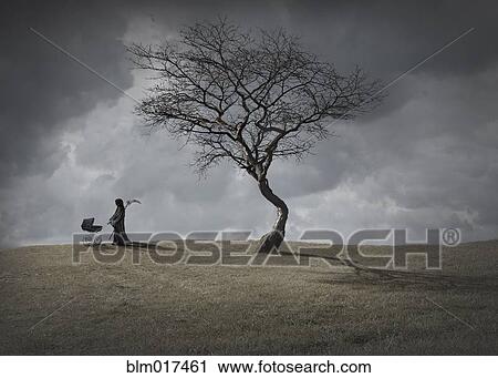 Man in black robes with baby carriage by dead tree View Large Photo Image Stock Image - Man in black robes with baby carriage by dead tree. Fotosearch