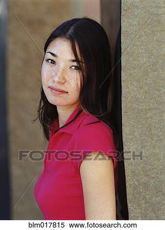 Mixed race woman leaning on wall View Large Photo Image Stock Photography - Mixed race woman leaning on wall. Fotosearch