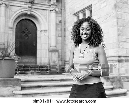 Mixed race woman smiling by church View Large Photo Image Stock Image - Mixed race woman smiling by church. Fotosearch