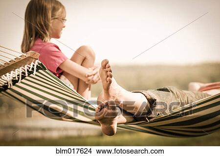 Mother and daughter relaxing in hammock outdoors View Large Photo Image Picture - Mother and daughter relaxing in hammock outdoors. Fotosearch