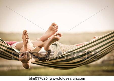 Mother and daughter relaxing in hammock outdoors View Large Photo Image Stock Photography - Mother and daughter relaxing in hammock outdoors. Fotosearch