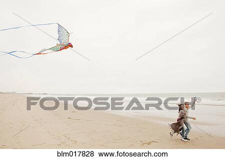 Older Caucasian couple flying kite on beach View Large Photo Image Stock Photo - Older Caucasian couple flying kite on beach. Fotosearch