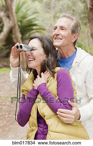 Older Caucasian couple using binoculars View Large Photo Image Picture - Older Caucasian couple using binoculars. Fotosearch