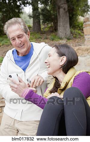 Older Caucasian couple using cell phone View Large Photo Image Stock Image - Older Caucasian couple using cell phone. Fotosearch