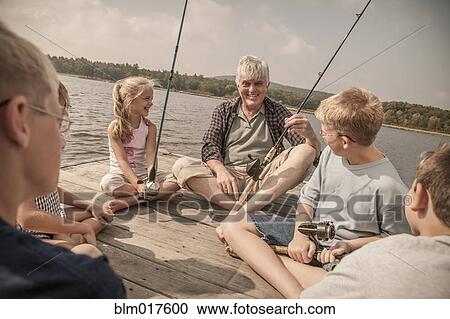 Older Caucasian man teaching grandchildren to fish View Large Photo Image Stock Image - Older Caucasian man teaching grandchildren to fish. Fotosearch