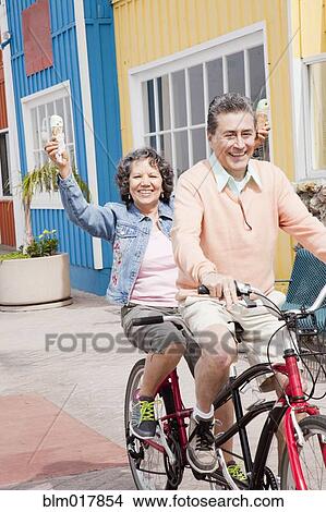 Older Hispanic couple riding tandem bicycle View Large Photo Image Picture - Older Hispanic couple riding tandem bicycle. Fotosearch