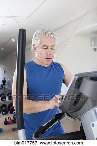 Older Hispanic man using elliptical machine in gym View Large Photo Image Stock Photo - Older Hispanic man using elliptical machine in gym. Fotosearch