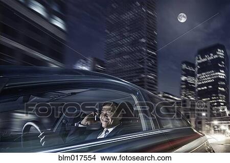Pacific Islander businessman driving on cell phone View Large Photo Image Picture - Pacific Islander businessman driving on cell phone. Fotosearch