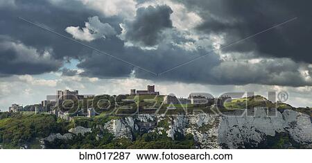 Stock Photo - Town built on white cliffs under stormy sky, Dover, Kent, England. Fotosearch