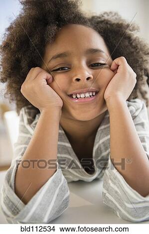 African American girl leaning on elbows View Large Photo Image Picture - African American girl leaning on elbows. Fotosearch