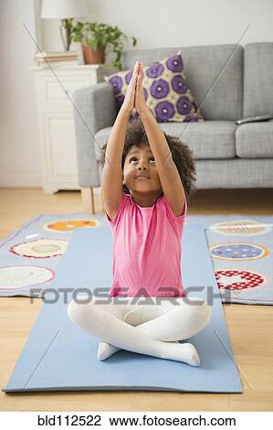 African American girl practicing yoga in living room View Large Photo Image Stock Image - African American girl practicing yoga in living room. Fotosearch