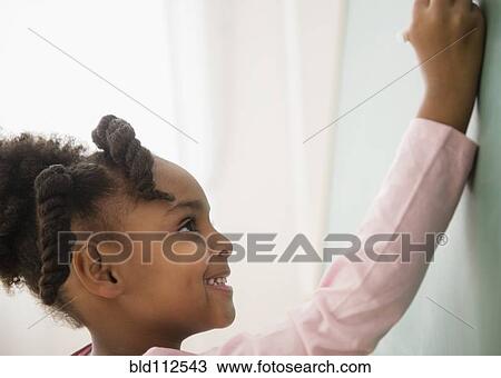 African American girl writing on chalkboard View Large Photo Image Stock Image - African American girl writing on chalkboard. Fotosearch