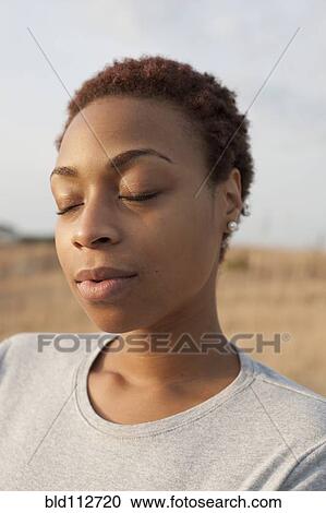 African American woman outdoors with eyes closed View Large Photo Image Stock Image - African American woman outdoors with eyes closed. Fotosearch