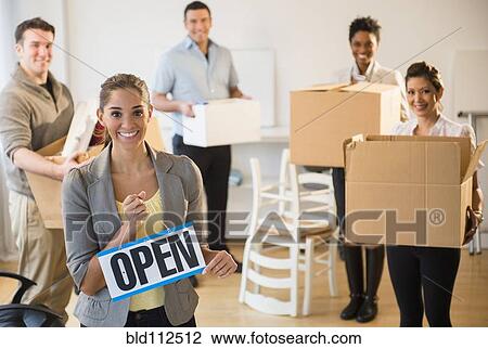 Stock Image - Business people opening new office. Fotosearch