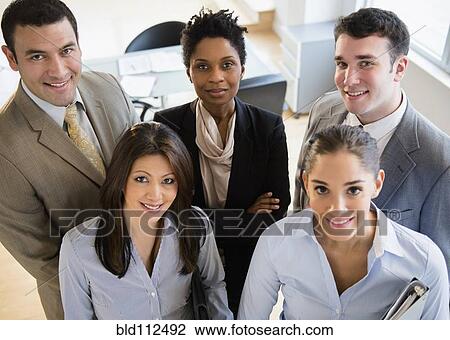 Business people smiling together in office View Large Photo Image Stock Image - Business people smiling together in office. Fotosearch