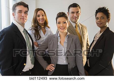 Stock Image -  Business people smiling together in office. Fotosearch