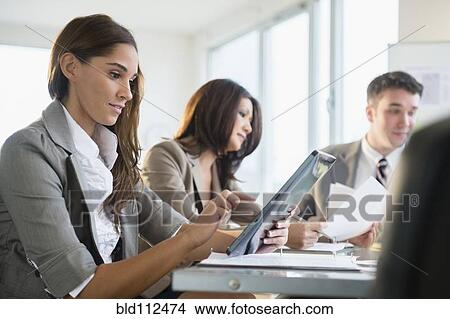 Picture - Business people working in meeting. Fotosearch
