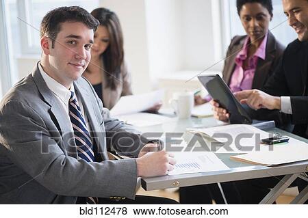 Stock Photo - Businessman smiling in meeting. Fotosearch