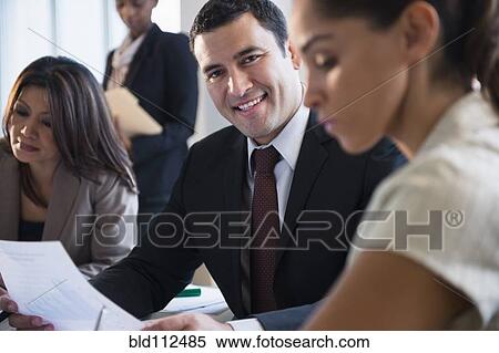 Businessman smiling in meeting View Large Photo Image Stock Photography - Businessman smiling in meeting. Fotosearch