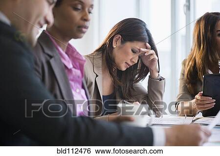 Stock Photograph - Businesswoman making notes in meeting. Fotosearch
