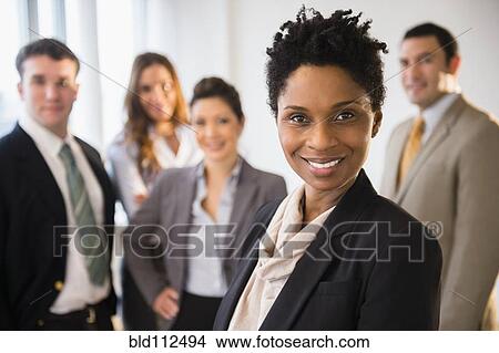 Picture -  Businesswoman smiling in office. Fotosearch