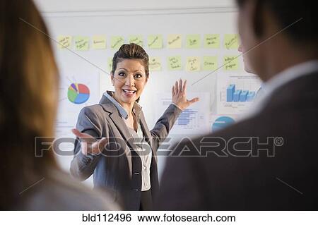 Stock Photograph - Businesswoman talking in meeting. Fotosearch