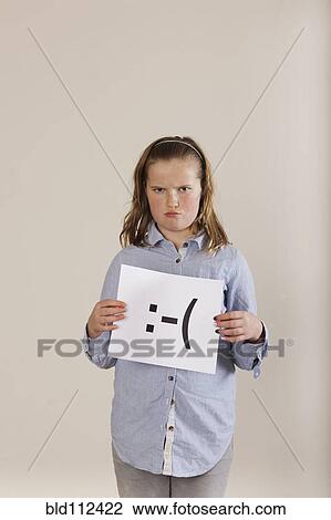 Caucasian boy holding card with sad face View Large Photo Image Stock Image - Caucasian boy holding card with sad face. Fotosearch