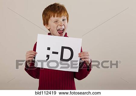Caucasian boy holding card with smiley face View Large Photo Image Stock Photo - Caucasian boy holding card with smiley face. Fotosearch