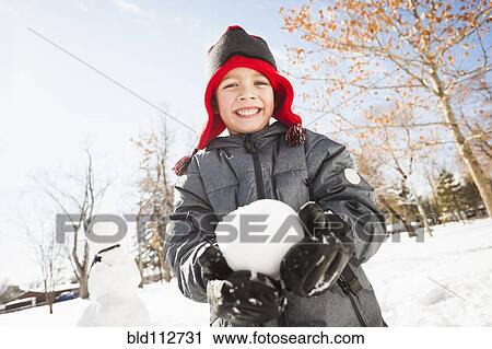 Caucasian boy holding snowball outdoors View Large Photo Image Stock Image - Caucasian boy holding snowball outdoors. Fotosearch