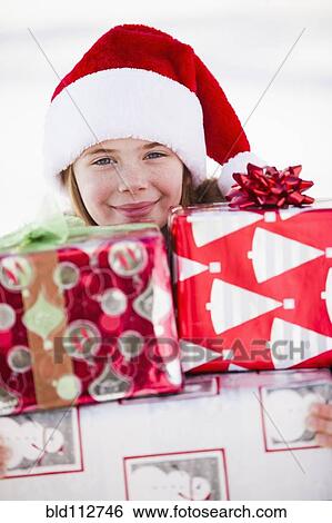 Caucasian boy in Santa hat holding Christmas presents View Large Photo Image Stock Photograph - Caucasian boy in Santa hat holding Christmas presents. Fotosearch