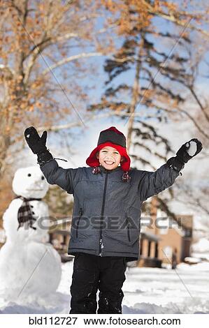 Stock Photo - Caucasian boy playing in snow. Fotosearch