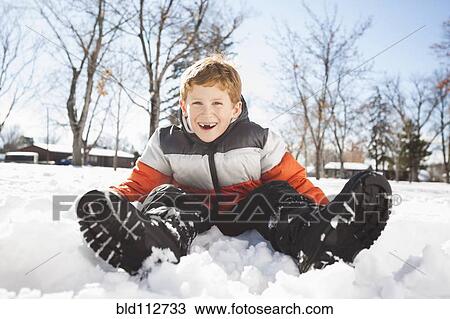 Caucasian boy sitting in snow outdoors View Large Photo Image Stock Image - Caucasian boy sitting in snow outdoors. Fotosearch