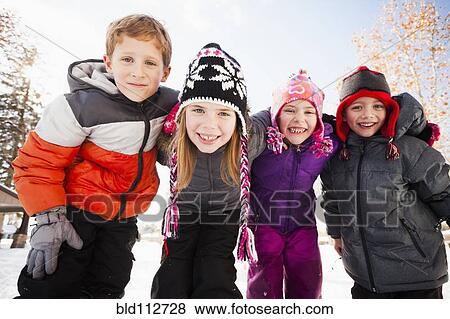 Stock Photo - Caucasian children smiling in snow. Fotosearch