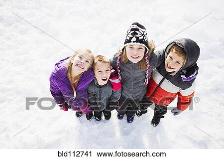 Caucasian children standing in snow outdoors View Large Photo Image Stock Image - Caucasian children standing in snow outdoors. Fotosearch