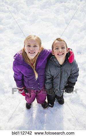 Caucasian children standing in snow outdoors View Large Photo Image Stock Image - Caucasian children standing in snow outdoors. Fotosearch