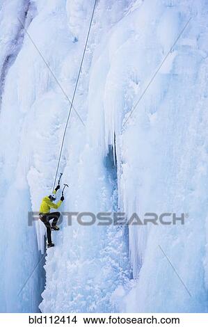 Picture - Caucasian climber scaling glacier. Fotosearch