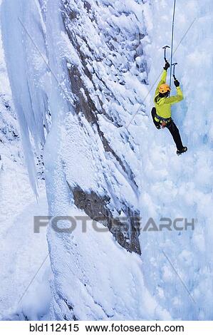 Stock Photography - Caucasian climber scaling glacier. Fotosearch