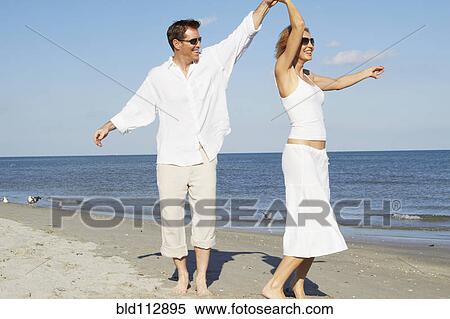 Caucasian couple dancing on beach View Large Photo Image Stock Photography - Caucasian couple dancing on beach. Fotosearch