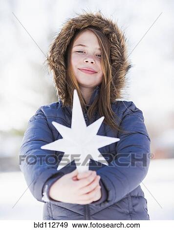 Caucasian girl holding decorative star View Large Photo Image Stock Photo - Caucasian girl holding decorative star. Fotosearch