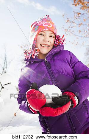 Caucasian girl holding snowball outdoors View Large Photo Image Stock Image - Caucasian girl holding snowball outdoors. Fotosearch
