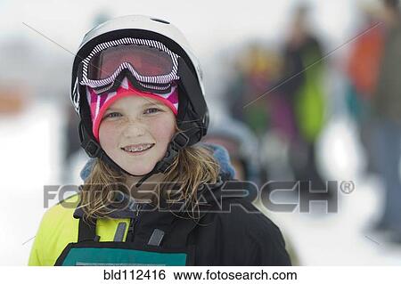 Stock Photograph - Caucasian girl wearing ski gear in snow. Fotosearch