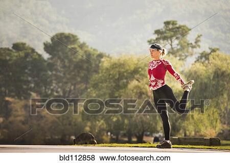 Caucasian runner stretching in park View Large Photo Image Stock Photo - Caucasian runner stretching in park. Fotosearch