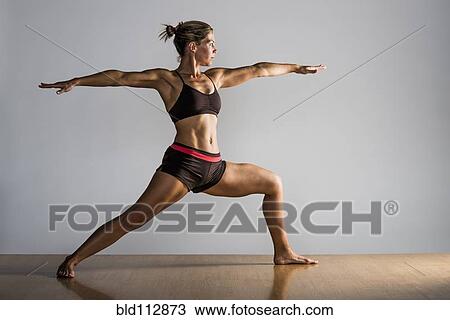 Caucasian woman practicing yoga in studio View Large Photo Image Stock Image - Caucasian woman practicing yoga in studio. Fotosearch