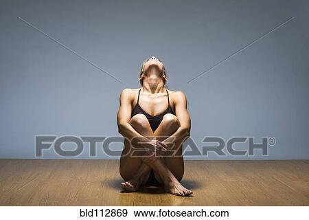 Stock Photo - Caucasian woman practicing yoga in studio. Fotosearch