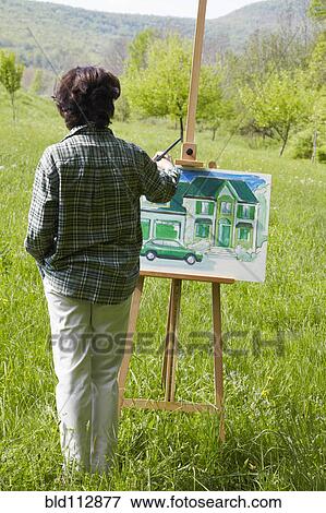 Caucasian woman visualizing house in rural landscape View Large Photo Image Stock Photo - Caucasian woman visualizing house in rural landscape. Fotosearch