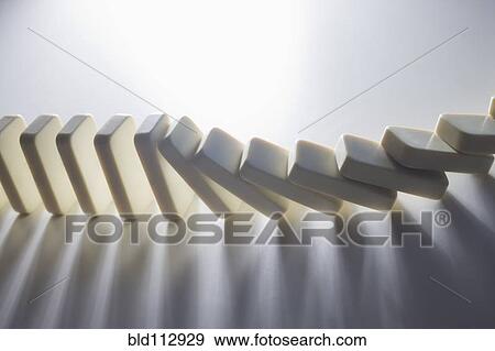 Stock Photo - Close up of falling dominoes. Fotosearch